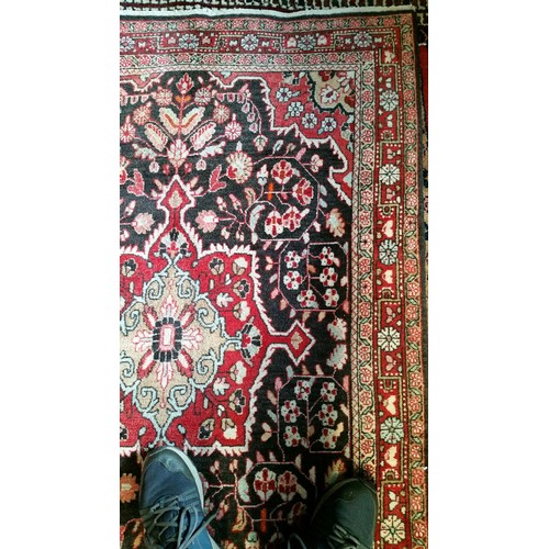 220 - A semi old handmade Iranian carpet with central medallion 100% pure wool full pile fringed to one en... 