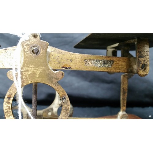 235 - 19th Century brass postal scales on a mahogany base with three brass weights in used condition