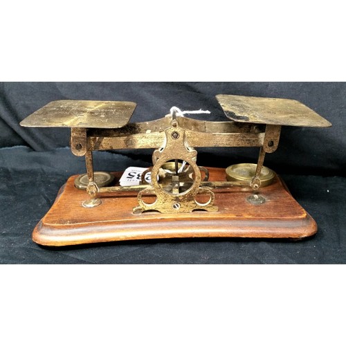 235 - 19th Century brass postal scales on a mahogany base with three brass weights in used condition