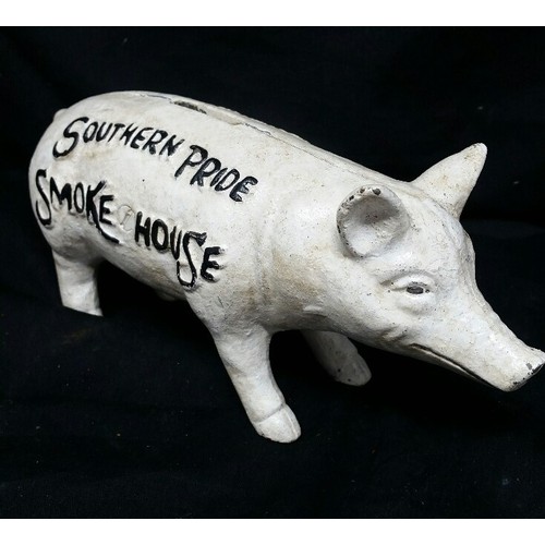 259 - A heavy cast iron pig moneybox. Southern Pride Smoke House. 8 inches long x 3.5 inches high. An anti... 