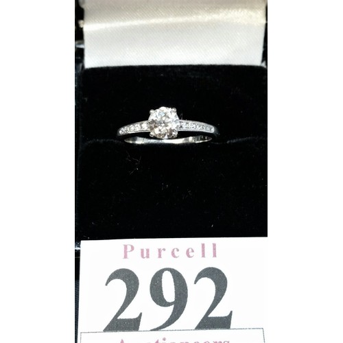 292 - A good platinum solitaire diamond ring flanked by diamond encrusted shoulders. Central diamond appro... 