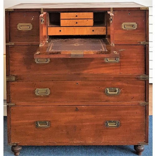 19th Century Mahogany Military Campaign Chest with miniature fall front secretaire opening to reveal three fitted satinwood drawers and compartments flanked with two small drawers raised over three long drawers with recessed brass pulls terminating on bun feet. c.39in wide, 19in deep, 42in tall