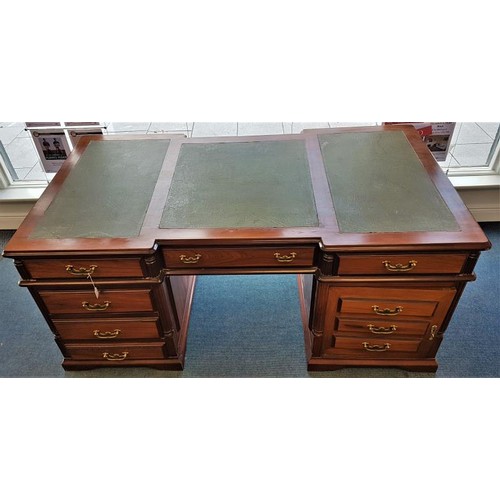 A large vintage, Georgian style Mahogany Partner’s Desk, dating from the second half of the 20th century. The desk top is of inverted breakfront outline and is fitted with three section green leather writing surface. Decorative panelled sides and elegant brass drop handles and is raised on shaped bracket feet. It is a partners desk, this one is identical on each side. Each side has three drawers across the frieze a pedestal which has a further three drawers and a pedestal which has a cupboard. A Victorian Mahogany Chair accompanies the desk. c.70ins long x 39ins deep x 30.5ins tall.