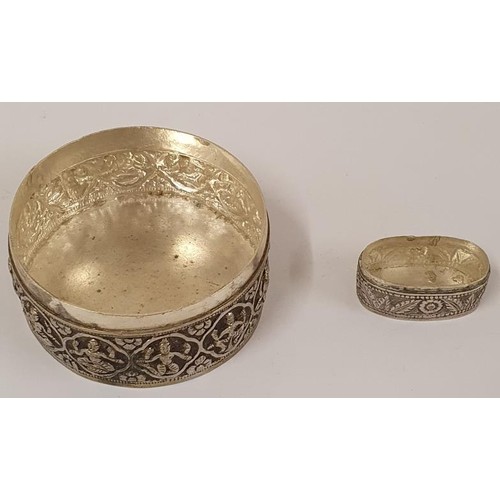 136 - Indian Embossed Silver Lidded Trinket Box and a similar Silver Pill Box, both not hallmarked.