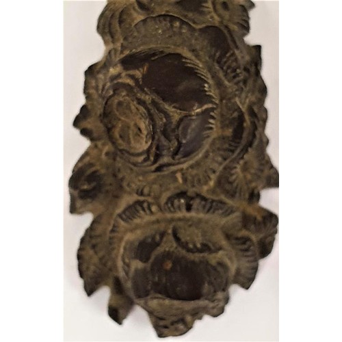 203 - Intricately hand carved hardwood cross, decorated with flowers, c.9cm