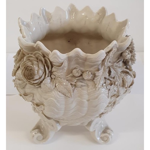 2nd Period Belleek Flower Pot (1891-1926), with scalloped top, floral detail on a swirling body and all raised the three legs. c.10.5in tall, 9.5in diameter