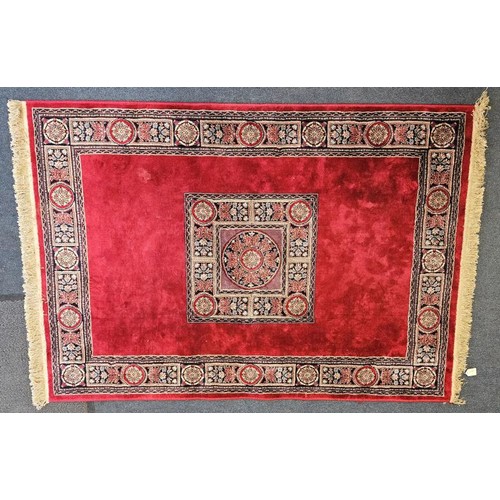 457 - Kashmir Silk Fibre Floor Rug, with a band of geometric and floral patterns and central crest on a de... 