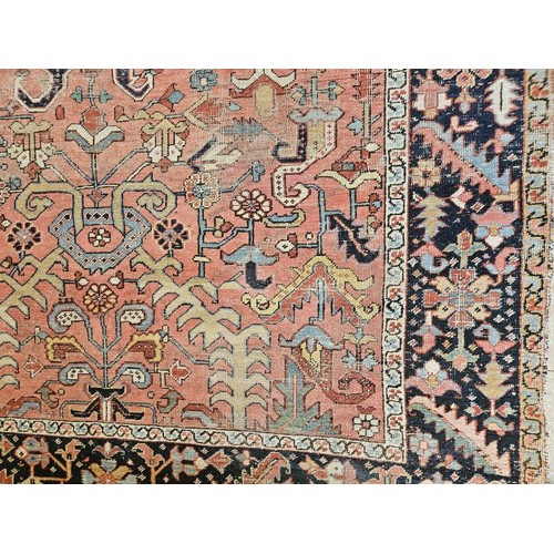 439 - Eastern Floor Rug, a large central panel with geometric shapes on a pink ground surrounded by furthe... 