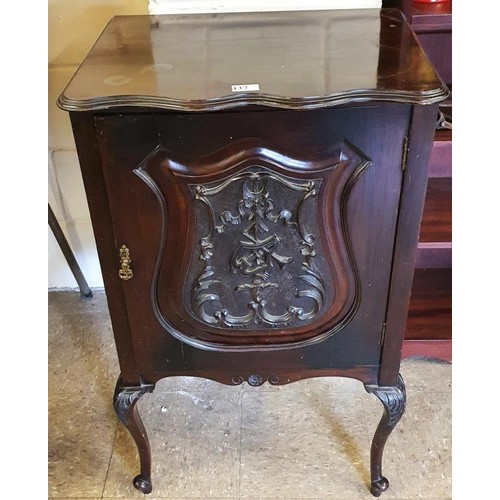 437 - Edwardian Mahogany Music Cabinet, the shaped top above a single door carved with musical instruments... 