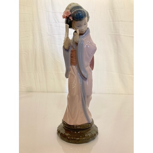 62 - Four Lladro figurines Jolie 5210 with Parasol, Pretty Picking 5222. Girl with Lilies, and a shy Geis... 
