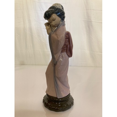 62 - Four Lladro figurines Jolie 5210 with Parasol, Pretty Picking 5222. Girl with Lilies, and a shy Geis... 