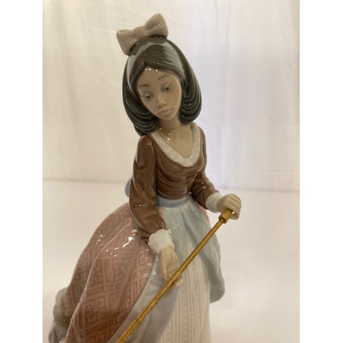 62 - Four Lladro figurines Jolie 5210 with Parasol, Pretty Picking 5222. Girl with Lilies, and a shy Geis... 