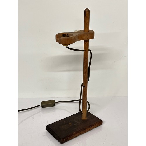 22 - Table lamp, an industrial wooden laboratory stand converted to a desk light, 55cm high

This lot is ... 