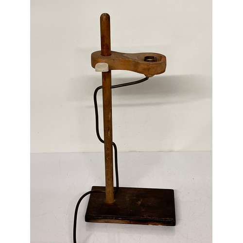 22 - Table lamp, an industrial wooden laboratory stand converted to a desk light, 55cm high

This lot is ... 