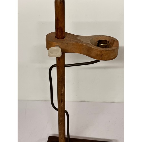 22 - Table lamp, an industrial wooden laboratory stand converted to a desk light, 55cm high

This lot is ... 