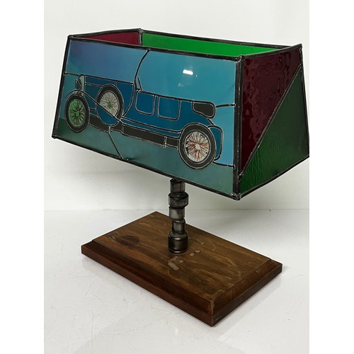 38 - Motoring themed table lamp, stained glass shade features a Le mans Bentley racing car, the lamp stem... 