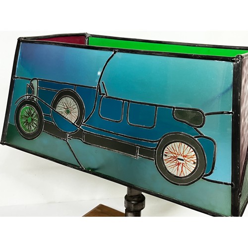 38 - Motoring themed table lamp, stained glass shade features a Le mans Bentley racing car, the lamp stem... 