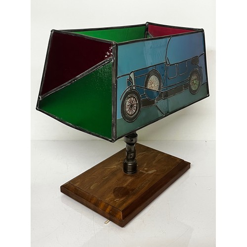 38 - Motoring themed table lamp, stained glass shade features a Le mans Bentley racing car, the lamp stem... 