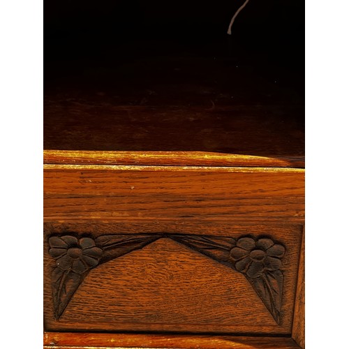 40 - A Marble topped storage unit of utilitarian design with carved decoration to the door and a lined cu... 