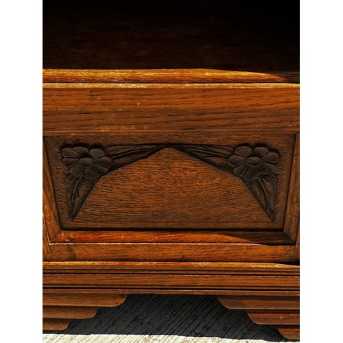 40 - A Marble topped storage unit of utilitarian design with carved decoration to the door and a lined cu... 