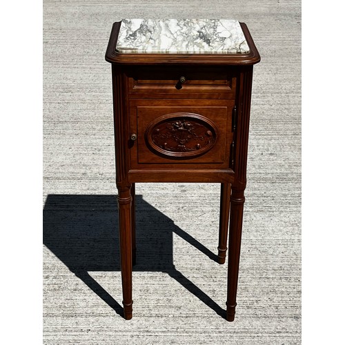 42 - A White Marble topped storage unit on long taped legs and with carved decoration to the door and a l... 