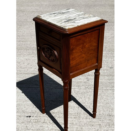 42 - A White Marble topped storage unit on long taped legs and with carved decoration to the door and a l... 