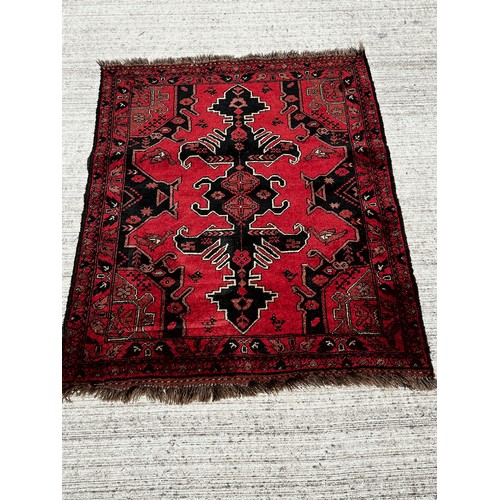 51 - Woollen floor Rug with a red and black colour way with lighter highlights to the designs.

This lot ... 