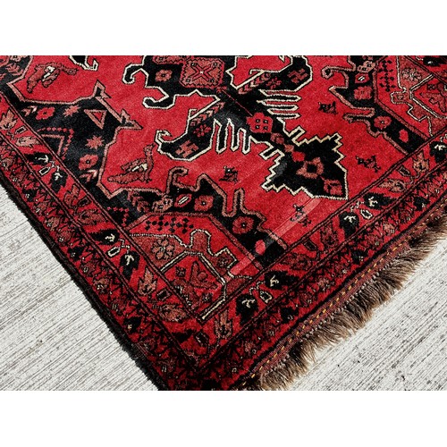 51 - Woollen floor Rug with a red and black colour way with lighter highlights to the designs.

This lot ... 