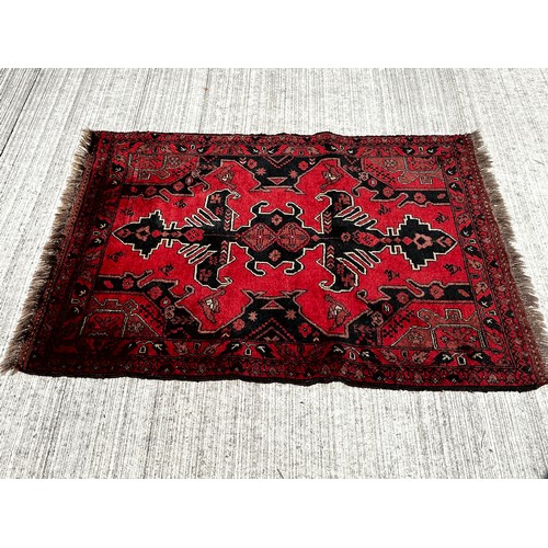 51 - Woollen floor Rug with a red and black colour way with lighter highlights to the designs.

This lot ... 