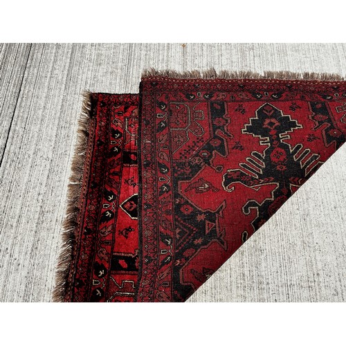 51 - Woollen floor Rug with a red and black colour way with lighter highlights to the designs.

This lot ... 