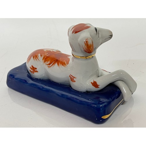 249 - Staffordshire greyhound figurine of a recumbent hound at rest on a blue cushion making the plinth fo... 