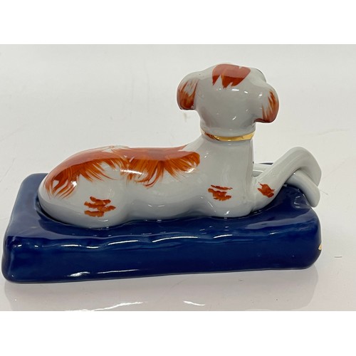 249 - Staffordshire greyhound figurine of a recumbent hound at rest on a blue cushion making the plinth fo... 