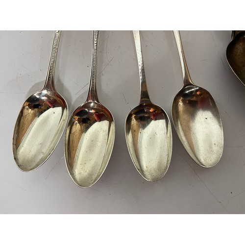 286 - Eight serving spoons, seven with english silver hallmarks and one without, 504 grams and the largest... 