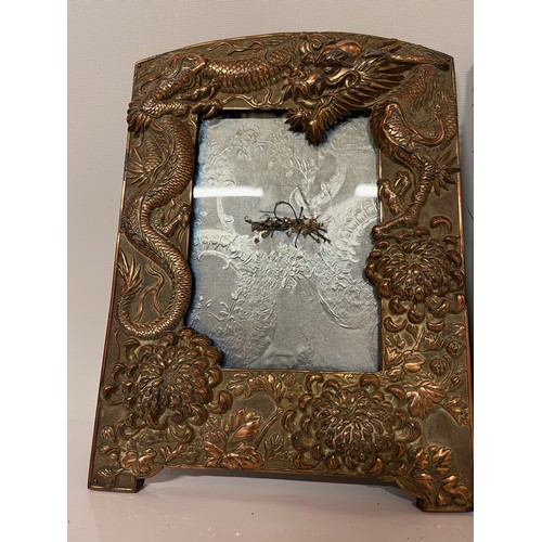 287 - Two plated copper picture frames decorated with three toed Dragons and Chrysanthemums, each is 10 in... 