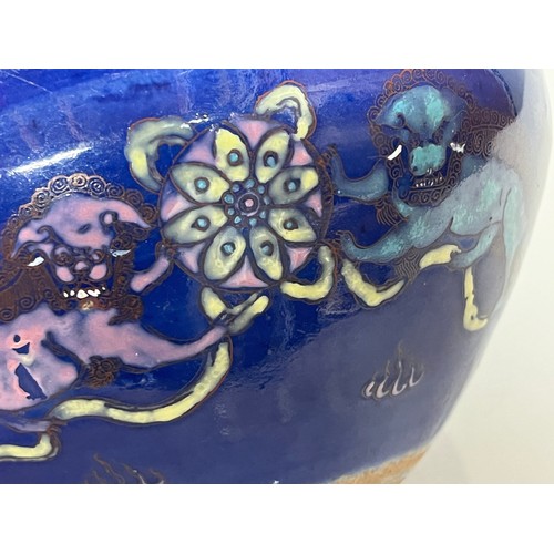 291 - Oriental stone ware bowl decorated with lions and floral wheels on a blue ground, 8 inches in diamet... 