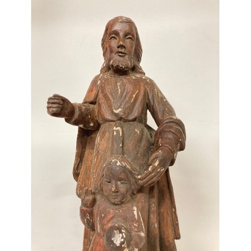 329 - C19th religious carved wooden figures of a man and a boy with painted jesso surface finish. 20 inche... 