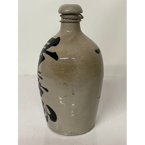 331 - Oriental stoneware Saki bottle, glazed lettering to front and rear. 10 inches high.

This lot is ava... 