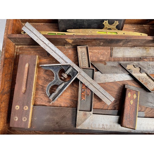 366 - Collection of woodworking and carpentry tools, A wooden box containing set squares and two spirit le... 