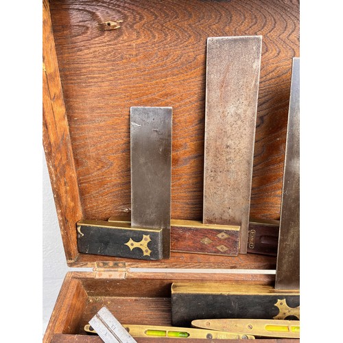 366 - Collection of woodworking and carpentry tools, A wooden box containing set squares and two spirit le... 