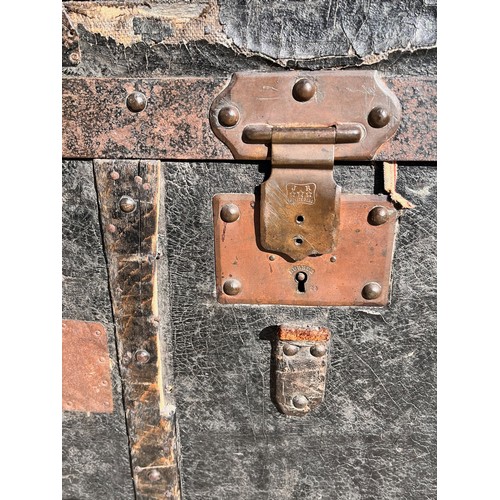 7 - Leather covered trunk with wood and metal bindings and inner tray, monogramed plaque to the top date... 