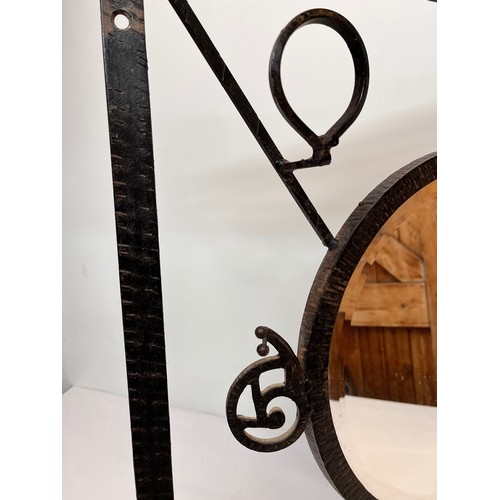 12 - Artisan made Arts and Crafts wrought iron unit, hat and coat rail with hall mirror to the centre, de... 