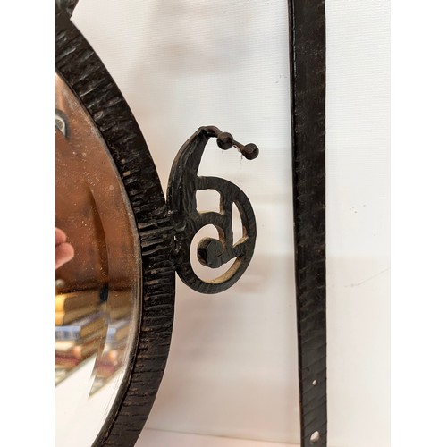 12 - Artisan made Arts and Crafts wrought iron unit, hat and coat rail with hall mirror to the centre, de... 