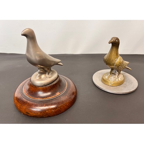 99 - Automobilia, two racing pigeon mascots wooden base is 12 cm in diameter and the metal one is 10 cm i... 