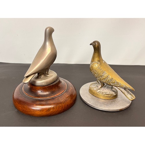 99 - Automobilia, two racing pigeon mascots wooden base is 12 cm in diameter and the metal one is 10 cm i... 