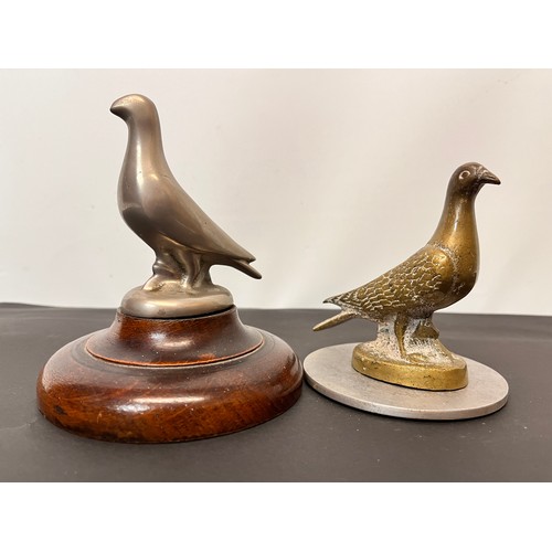 99 - Automobilia, two racing pigeon mascots wooden base is 12 cm in diameter and the metal one is 10 cm i... 