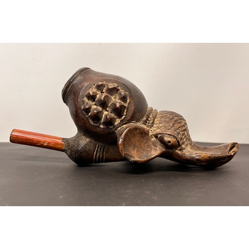 101 - Tribal art pipe in the form of an Elephant, 18cm long overall.

This lot is available for in-house s... 