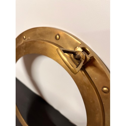 129 - Brass port hole 38 cm wide overall.


This lot is available for in-house shipping