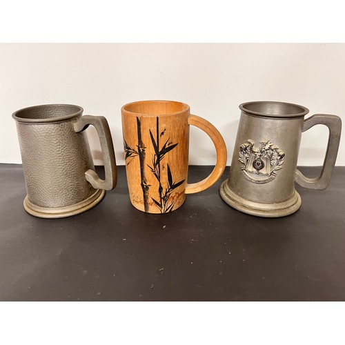 137 - Three tankards, two in pewter and a bamboo example that has been used as a brush pot.

This lot is a... 