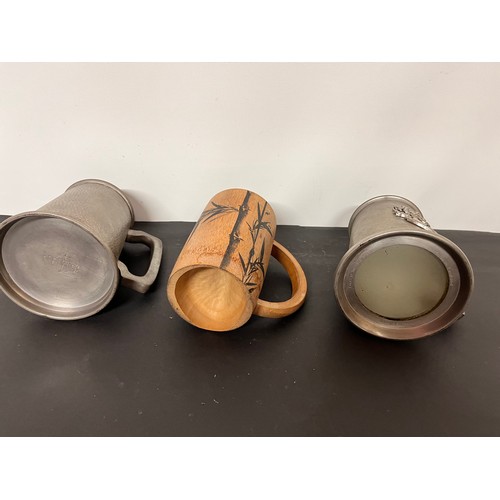 137 - Three tankards, two in pewter and a bamboo example that has been used as a brush pot.

This lot is a... 