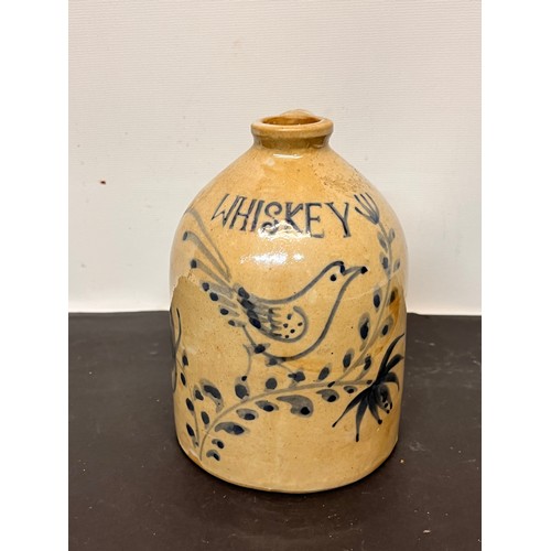 147 - Stoneware Whiskey flagon decorated with a bird in a floral composition.

15 cm high overall.

This l... 